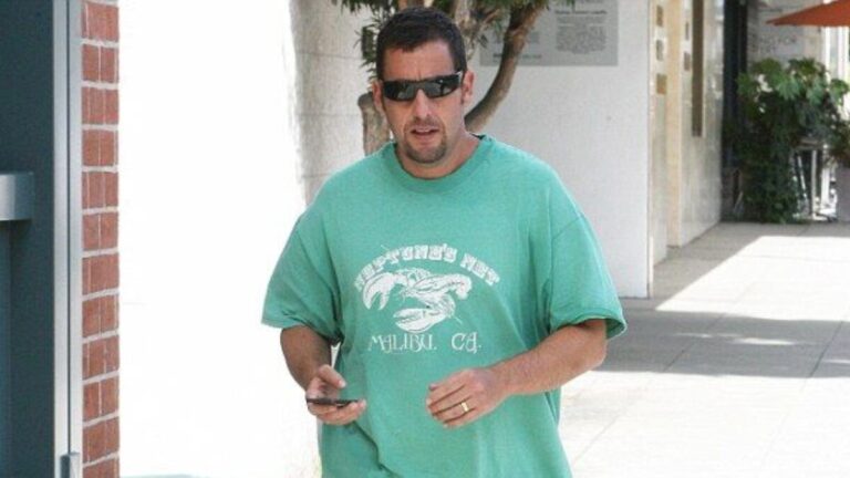 Unfiltered paparazzi photo of Adam Sandler in casual attire, embodying the signature elements of the Adam Sandler aesthetic.