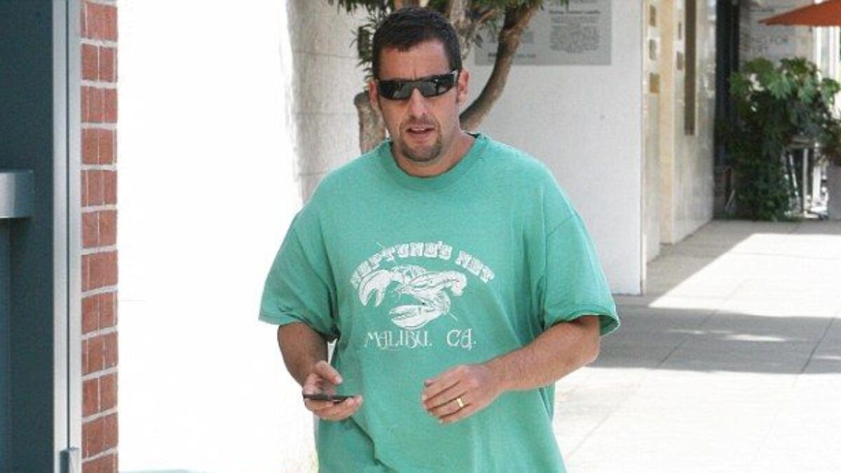 Unfiltered paparazzi photo of Adam Sandler in casual attire, embodying the signature elements of the Adam Sandler aesthetic.