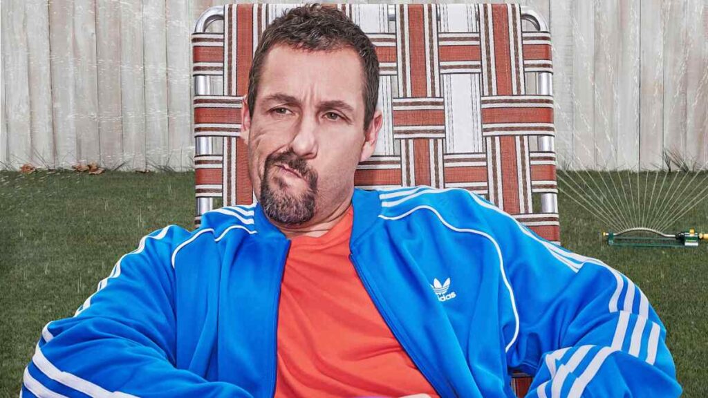 Adam Sandler seated casually in oversized clothes, embodying his signature comfort-first style — a visual expression of the “Beyond Clothes” aesthetic.
