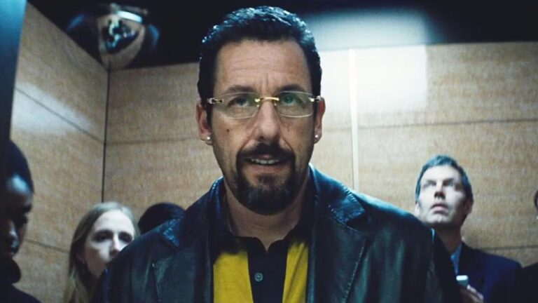 Adam Sandler in Uncut Gems, portraying Howard Ratner in a tense and dramatic scene from the film.