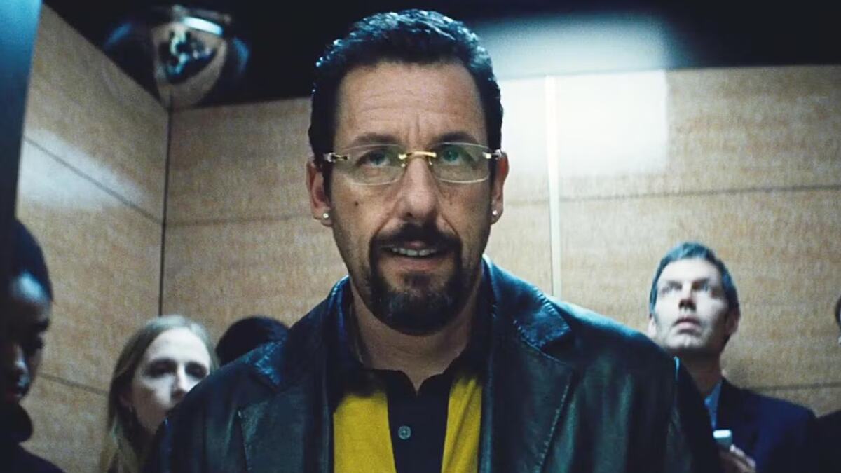 Adam Sandler in Uncut Gems, portraying Howard Ratner in a tense and dramatic scene from the film.