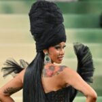 Cardi B Brand Empire — the rapper turned business mogul posing in high-fashion, symbolizing her success in music, fashion, and global endorsements.