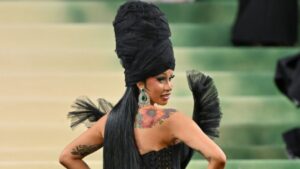 Cardi B Brand Empire — the rapper turned business mogul posing in high-fashion, symbolizing her success in music, fashion, and global endorsements.
