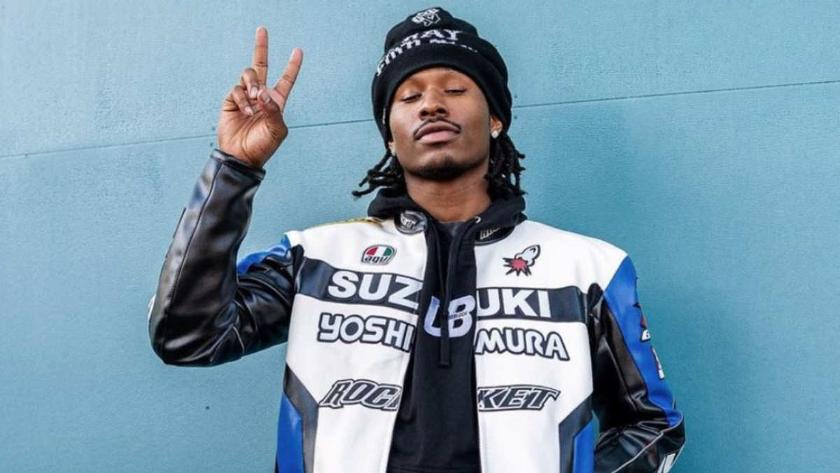 Duke Dennis posing in AMP merch, showcasing the creator behind the million dollar gamer phenomenon.