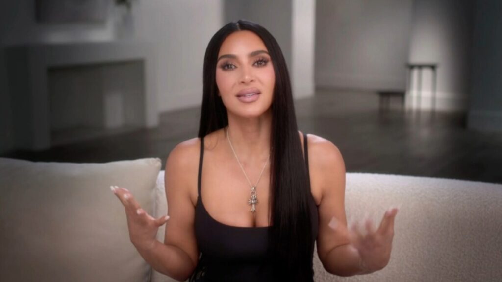 Kim Kardashian at a business event, symbolizing her reinvention from reality TV star to successful entrepreneur in fashion, beauty, and advocacy.