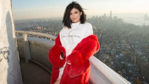 Kylie Jenner at a brand event representing the growth of the Kylie Jenner Empire, showcasing her role as a beauty mogul and entrepreneur.