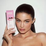 Kylie Jenner promoting Kylie Cosmetics Lip Kits with signature packaging and glam aesthetic