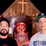 Matt Rife standing in the Annabelle Doll House he recently purchased, blending comedy with paranormal branding.
