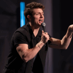 Matt Rife smiling during stand-up tour, representing his growing legacy in entertainment and comedy.