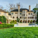 Offset Atlanta Mansion exterior view of the $5.8M luxury estate with grand driveway and landscaped grounds