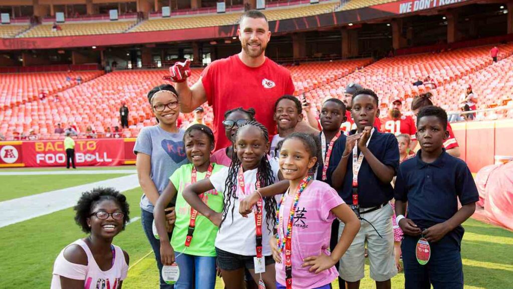 Travis Kelce philanthropy work through Eighty-Seven & Running foundation supporting youth and community programs