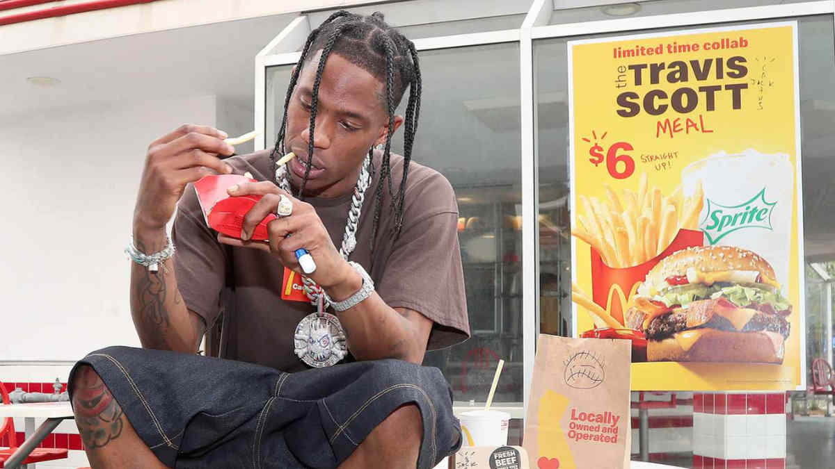 Travis Scott posing with branded collaborations including McDonald’s, Nike, and Dior — showcasing his influence across fashion, food, and culture.