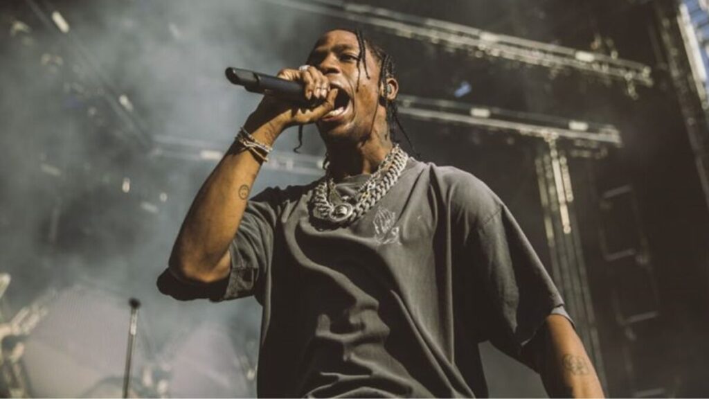 Travis Scott at a promotional event, symbolizing the expansion of his business empire beyond music.