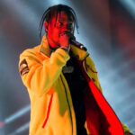 Travis Scott standing on stage during concert, representing his multimillion-dollar music and brand empire — Travis Scott net worth