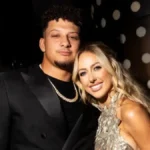 Brittany Mahomes & Patrick Mahomes smiling together at an NFL event, showcasing their relationship as a power couple.