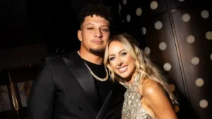Brittany Mahomes & Patrick Mahomes smiling together at an NFL event, showcasing their relationship as a power couple.