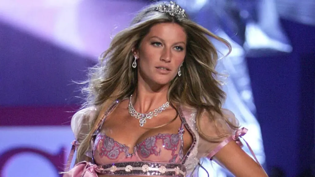 Gisele Bündchen walking the runway in an iconic fashion show, showcasing her supermodel legacy and cultural influence