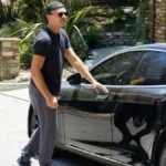 Leonardo DiCaprio cars collection featuring his Toyota Prius, Tesla Roadster, Fisker Karma, and Porsche Cayenne