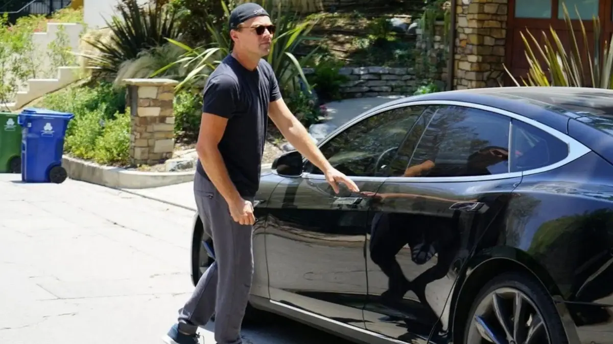 Leonardo DiCaprio cars collection featuring his Toyota Prius, Tesla Roadster, Fisker Karma, and Porsche Cayenne