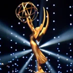 Close-up of the official Daytime Emmy Awards 2025 trophy — a golden winged woman holding an atom, symbolizing excellence in daytime television, gleaming under stage lights.