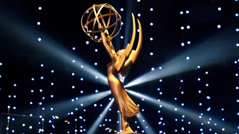 Close-up of the official Daytime Emmy Awards 2025 trophy — a golden winged woman holding an atom, symbolizing excellence in daytime television, gleaming under stage lights.