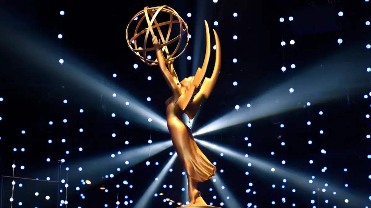 Close-up of the official Daytime Emmy Awards 2025 trophy — a golden winged woman holding an atom, symbolizing excellence in daytime television, gleaming under stage lights.