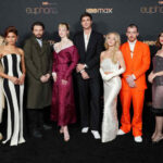 Ensemble photo of Euphoria Season 3 cast, reflective night city scene