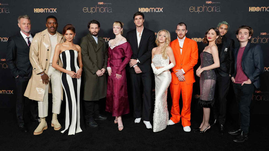 Ensemble photo of Euphoria Season 3 cast, reflective night city scene