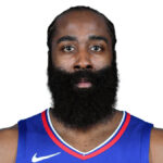 Close-up of James Harden with his signature beard, wearing a team jersey, looking directly at the camera.