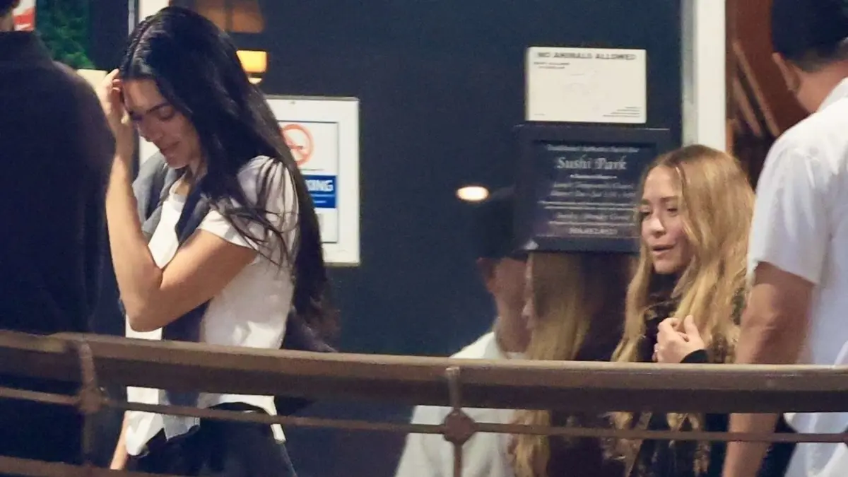 Kendall Jenner and Mary-Kate Olsen photographed arriving at an upscale restaurant, dressed elegantly in neutral tones.
