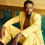 Kevin McCall, American singer and music producer, posing in a black jacket against a neutral background.