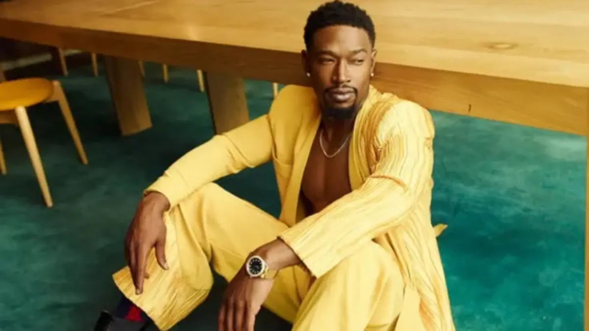 Kevin McCall, American singer and music producer, posing in a black jacket against a neutral background.