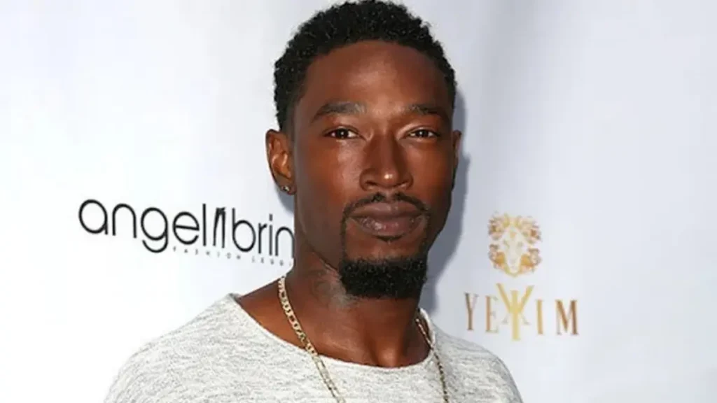 Portrait of Kevin McCall looking off to the side, ambient low-key lighting highlighting his silhouette, the words ‘2025 Confession’ in bold letters beneath.