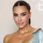 Kim Kardashian attending an event in a sleek outfit, appearing confident and healthy under bright lights.