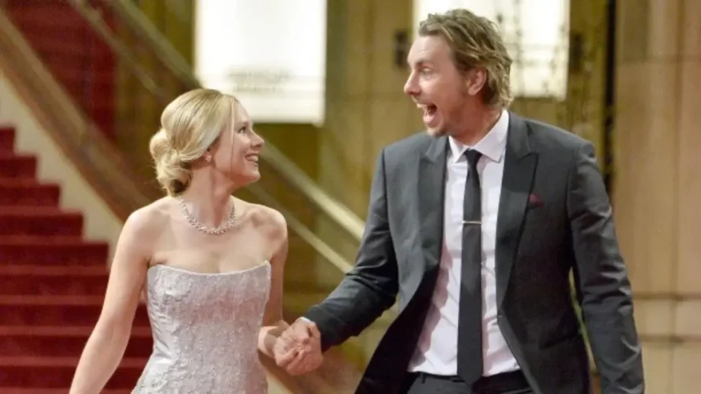 Kristen Bell laughing as Dax Shepard holds her hand, the couple celebrating their marriage with joyful expressions.