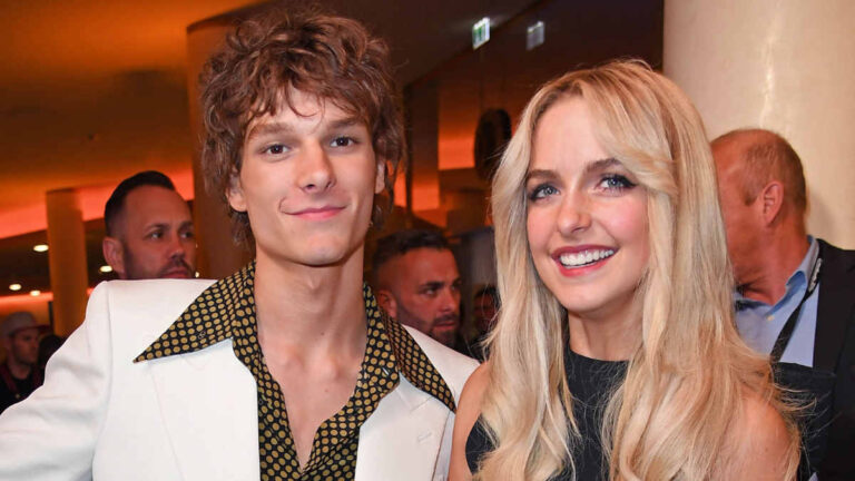 Actors Mason Thames and McKenna Grace posing together on the red carpet, smiling for photos, dressed in coordinated formal outfits.