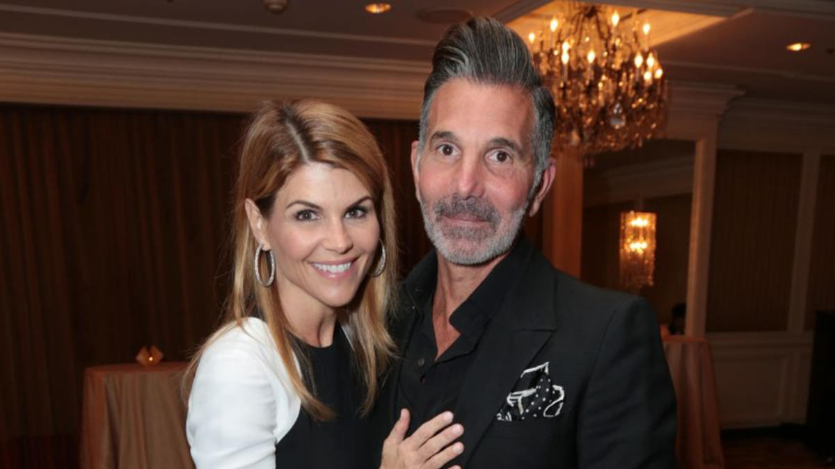 Mossimo Giannulli and Lori Loughlin pose together at a red carpet event