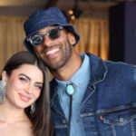Rachael Kirkconnell and Matt James smile for a photo at an event