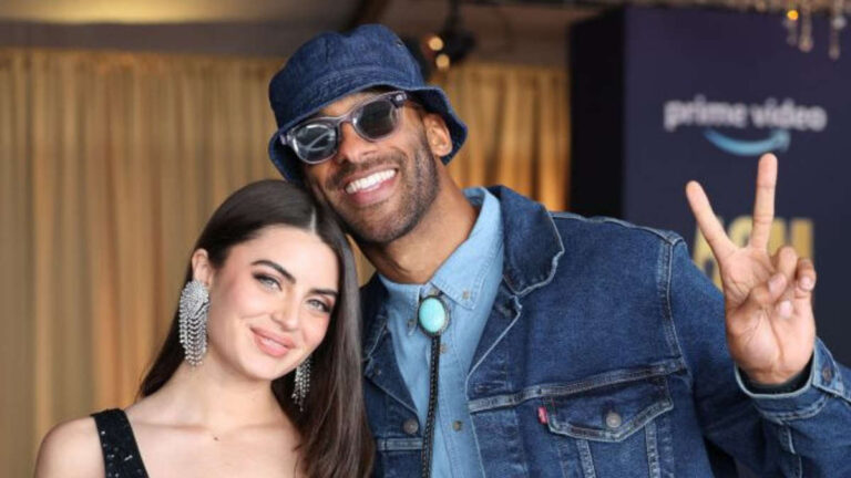 Rachael Kirkconnell and Matt James smile for a photo at an event